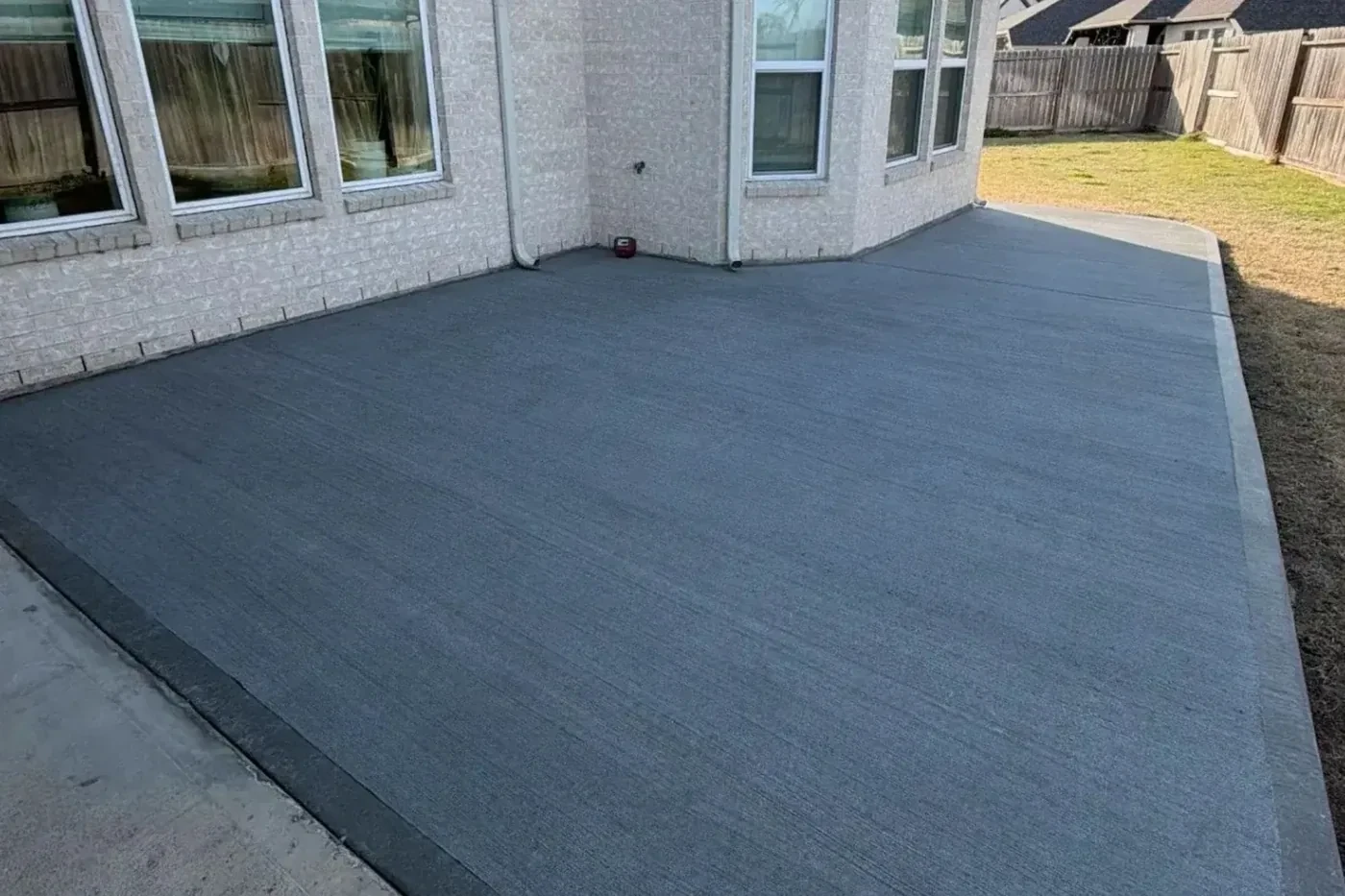 Finished broom-finish residential concrete patio by Lucky's Concrete